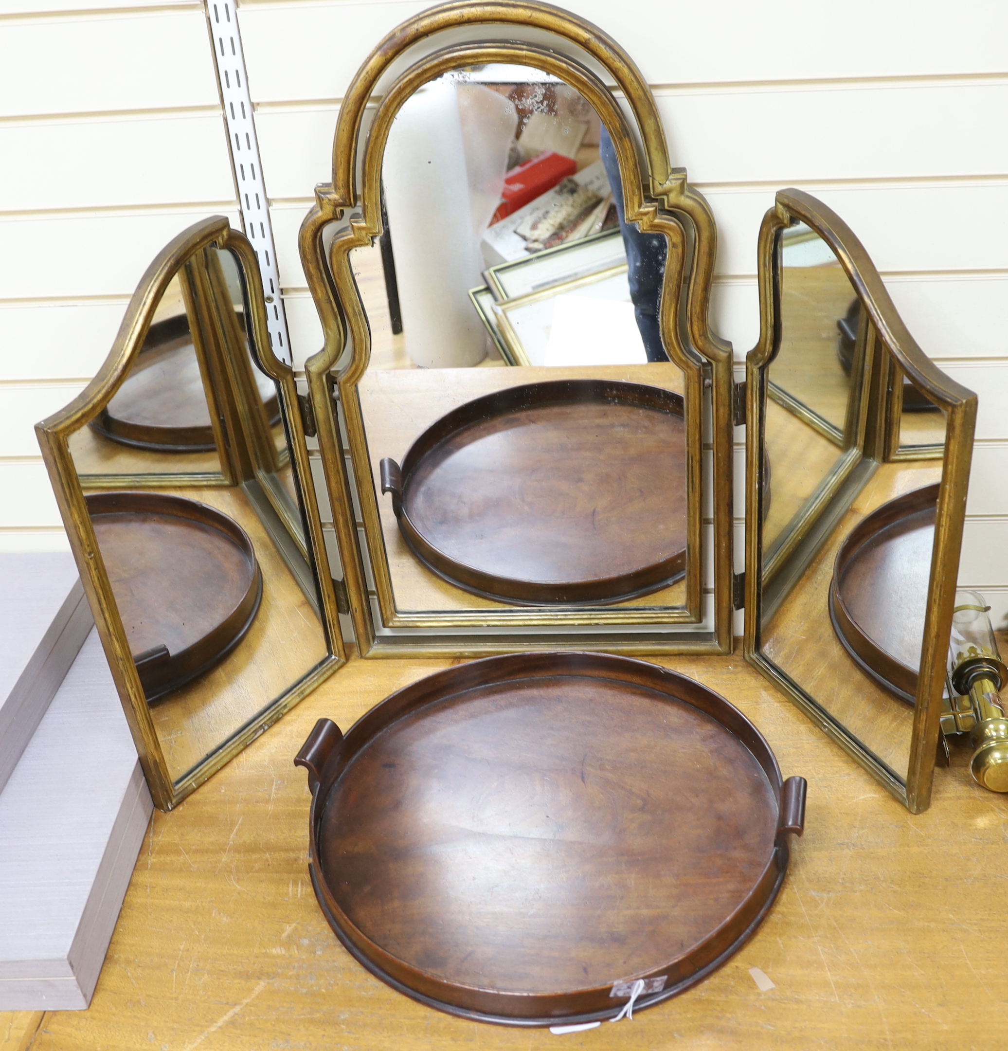 A circular mahogany tray and a gilt painted triptych mirror, central height of mirror 77cm high
